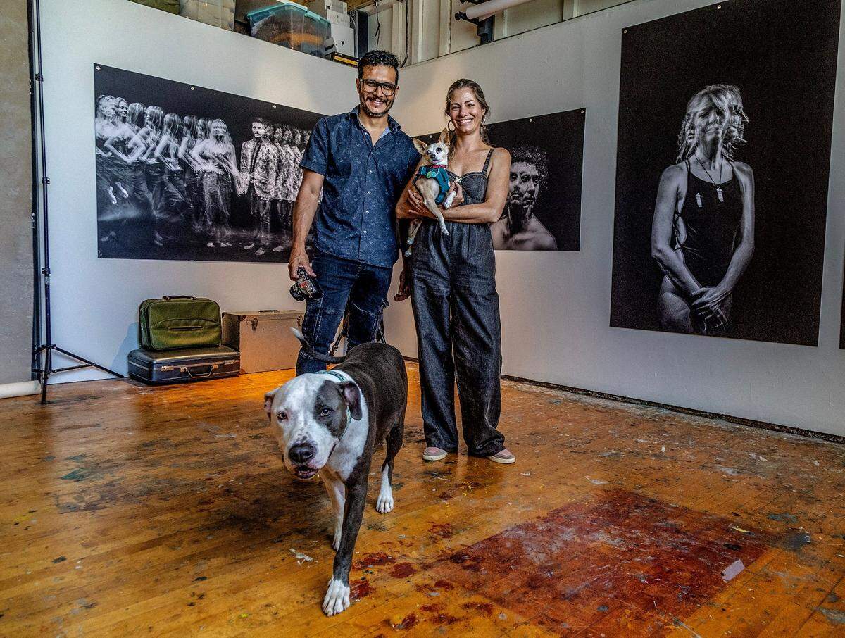 Artists Diana Espin and Pedro Wazzan pose with their rescued dogs Bruno, a Pitfall, and Pirulin, a Chihuahua mix, in their studio at the Bakehouse Art Complex during the Artists Open, a county-wide open studios event that welcomed the public into over 300 artists’ studios all over Miami-Dade on Saturday, May 13 , 2023.