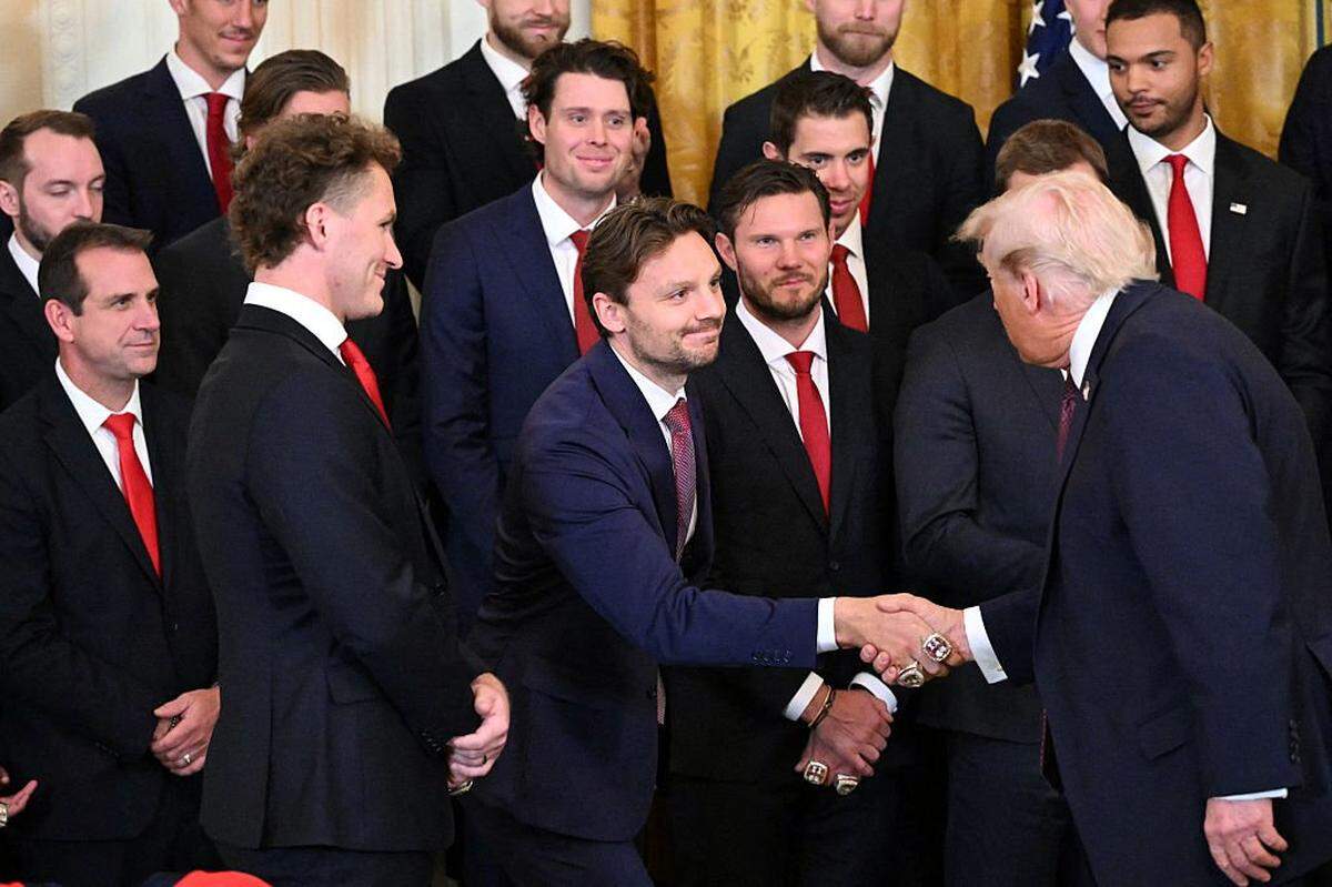 US President Donald Trump shakes hands to congratulate players of the Florida Panthers of the National Hockey League, winners of the 2025 Stanley Cup, during a ceremony in the East Room of the White House in Washington, DC on January 15, 2026. (Photo by Mandel NGAN / AFP via Getty Images)