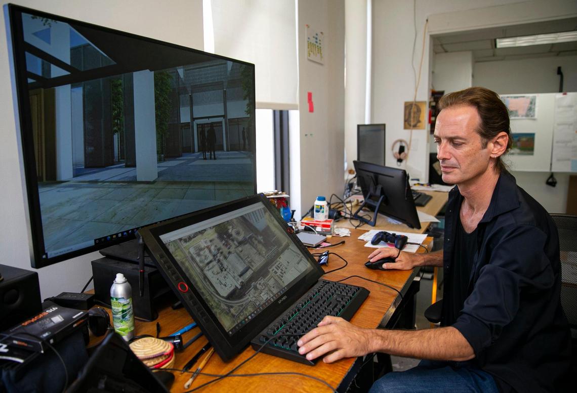 Joe Clark, lead architect for entrepreneur Moishe Mana’s Mana Common venture, shows design renderings for renovation projects in downtown Miami’s Flagler Street district. Clark works in a creative studio atop one of Mana’s downtown office buildings.