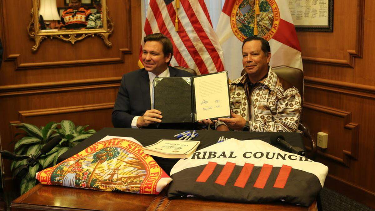 Gov. Ron DeSantis and Marcellus Osceola Jr., chairman of the Seminole Tribe, sign a gaming compact in the governor’s office at the Capitol in Tallahassee on Friday, April 23, 2021.