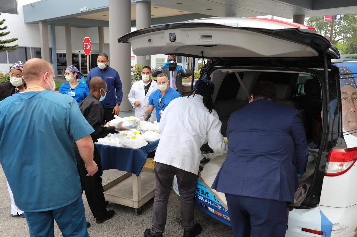 Chef Ivan of Ivan’s Cookhouse, a Caribbean-Asian fusion restaurant in North Miami Beach, unloads meals for the medical staff at Jackson North Medical Center.