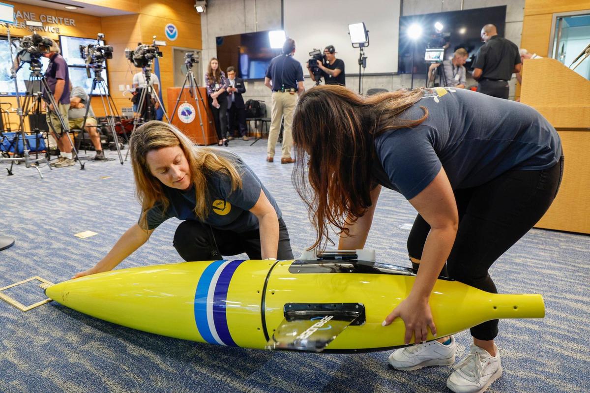 Laura Chaibongsai and Rayne Sabatello, communications specialists with NOAA’s Atlantic Oceanographic & Meteorological Lab, assemble a Sea Glider. The device is an oceanographic instrument that collects temperature and salinity data in the Atlantic Ocean during hurricane season. The Sea Glider was on display during a press conference at the operation center at the National Hurricane Center in Miami, FL on Friday, May 31, 2024.