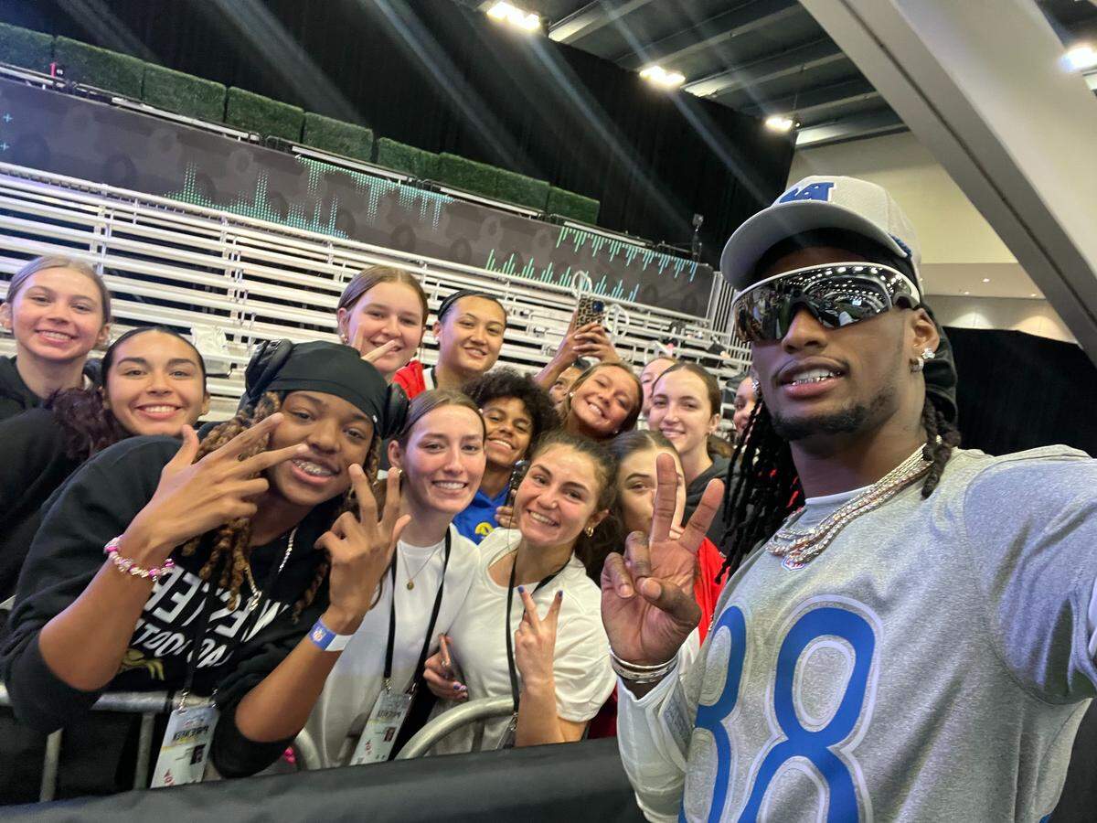 Western’s Cherish Huggins (left), along with her AFC teammates, meets Dallas Cowboys’ wide receiver CeeDee Lamb (right) at the Girls’ Flag Football Showcase in San Francisco this past week.