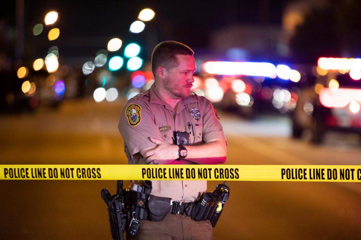 Miami-Dade Police work a crime scene around Northwest 62nd Street and Seventh Avenue in Miami, Florida on Monday, June 15, 2022. A Miami-Dade police officer was shot after a car chase in Liberty City on Monday night, multiple law-enforcement sources said.