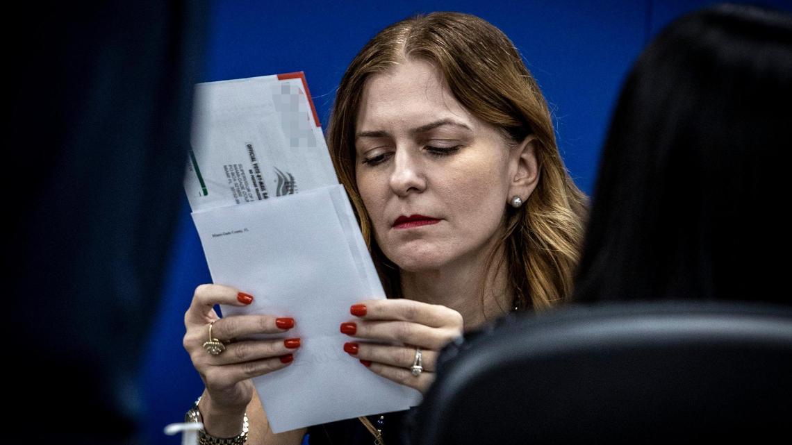 Miami-Dade County Supervisor of Elections Christina White inspects the signature on a vote-by-mail ballot at the Miami-Dade County Elections Department in Doral, Florida, where the Canvassing Board met on Oct. 20, 2022.