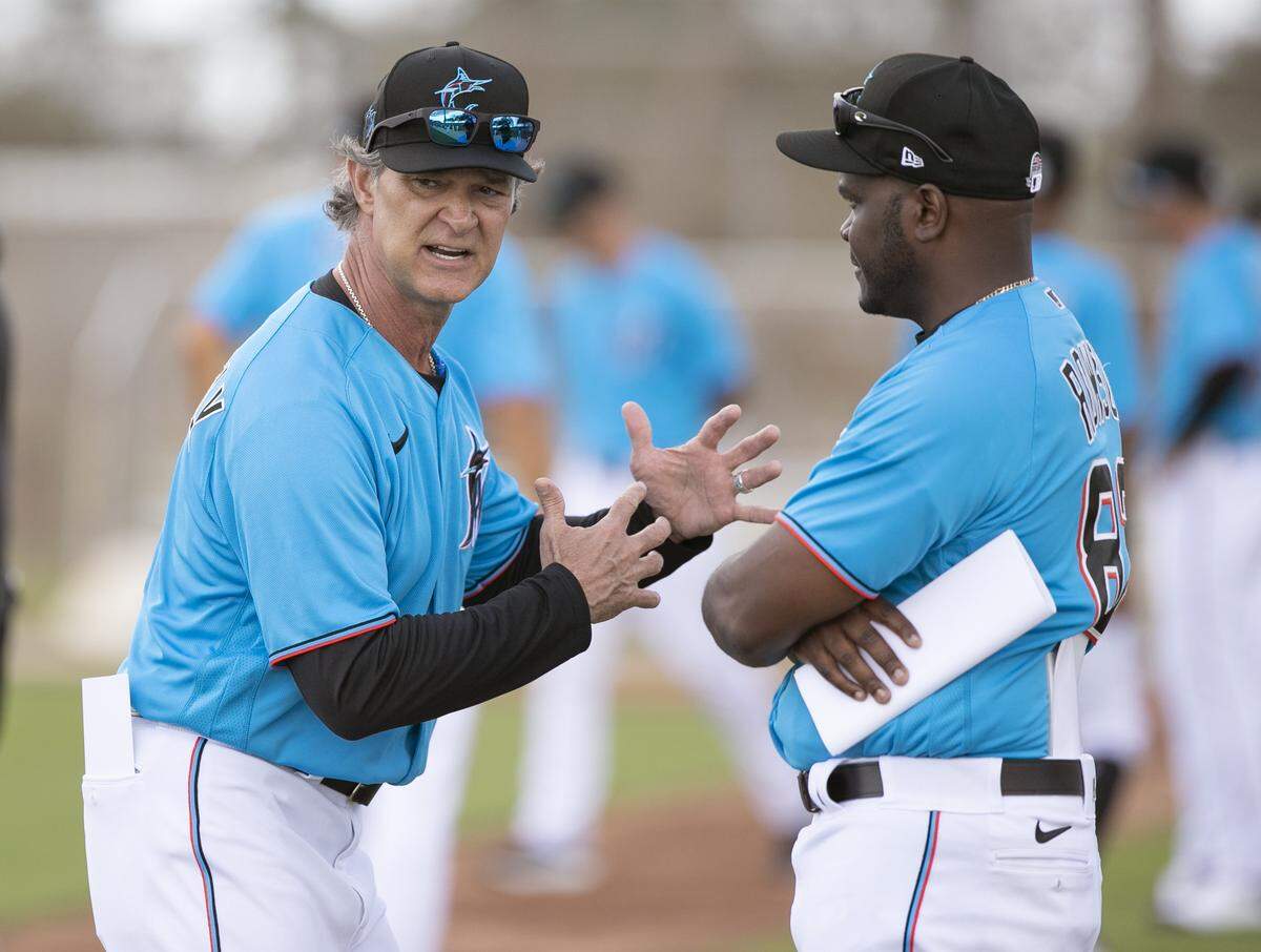 Miami Marlins Manager Don Mattingly , left, gestures as he speaks with bench coach James Rowson during spring training at the Roger Dean Chevrolet Stadium in Jupiter on Wednesday, February 19, 2020.