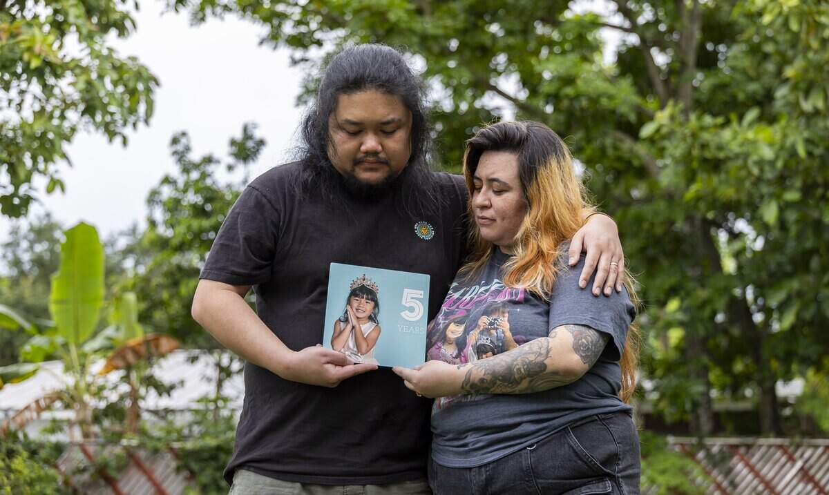 Danny Tran and his wife, Samari Curbelo, hold a photograph of their daughter, Harlow Jet Tran, 6, in the backyard of their home on Wednesday, June 3, 2026, in Coral Springs, Fla. Harlow was killed in a car accident, after a man fleeing a Coral Springs officer on May 5, 2024, struck the SUV driven by her great-grandmother. The family has filed a wrongful-death lawsuit against the city.