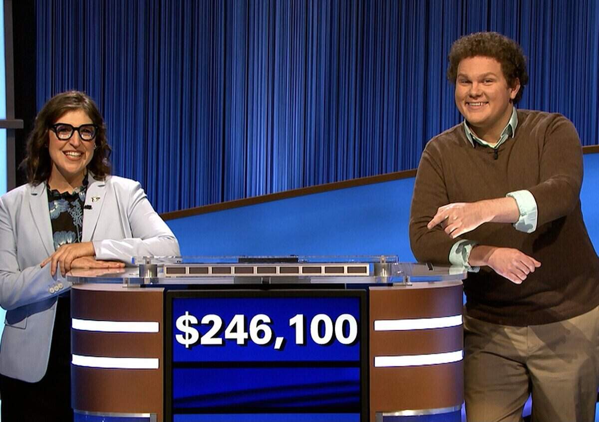 “Jeopardy!” host Mayim Bialik and 11-day champ Jonathan Fisher, who is from Coral Gables, pose on the California set after Fisher’s run ended on an episode broadcast Oct. 26, 2021.