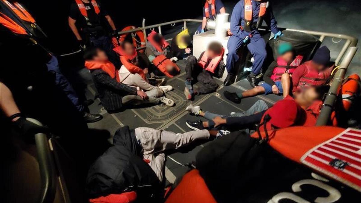 U.S Coast Guard crew members process migrants who were found on a smuggling boat Tuesday, Feb. 11, 2025, by Customs and Border Protection agents off Key Biscayne. The people on board were from China, Haiti and Bangladesh, according to the Homeland Security Investigations complaint and the Coast Guard.