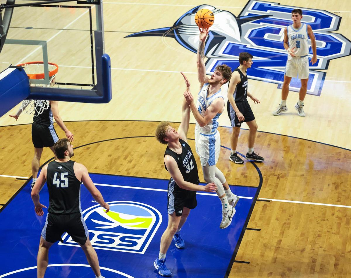 NSU Sharks Ryker Cisarik (5) shoots over UAH Chargers Matt Thurman(32) during the first half of a NCAA Division II Regional final on Tuesday, March 18, 2025, in the Rick Case Arena at Nova Southeastern University in Davie, Fla. The winner advances to the Elite Eight.