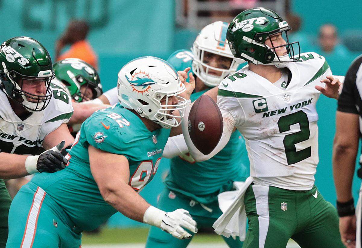 Miami Dolphins defensive end Zach Sieler (92) causes New York Jets quarterback Zach Wilson (2) to fumble in the second half at Hard Rock Stadium in Miami Gardens on Sunday, December 19, 2021.