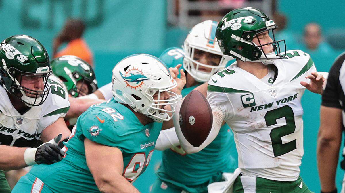 Miami Dolphins defensive end Zach Sieler (92) causes New York Jets quarterback Zach Wilson (2) to fumble in the second half at Hard Rock Stadium in Miami Gardens on Sunday, December 19, 2021.