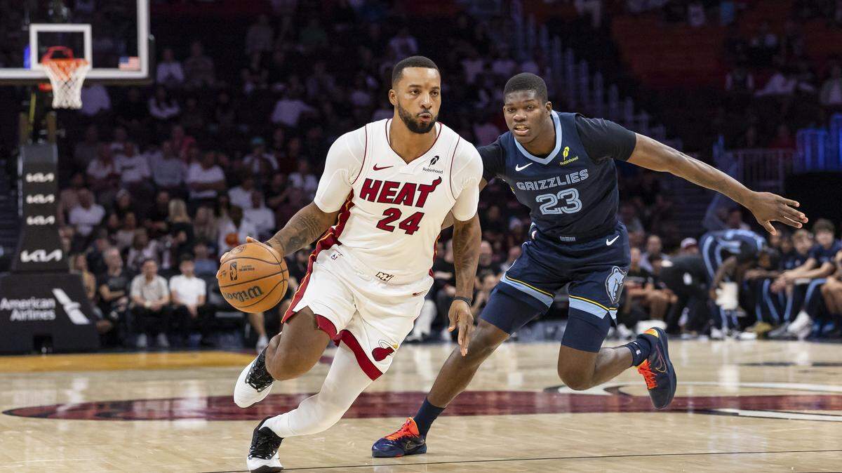 Miami Heat guard Norman Powell (24) drives the ball as Memphis Grizzlies guard Cedric Coward (23) defends in the first half of their NBA preseason game at Kaseya Center on Oct. 17, 2025, in Miami.