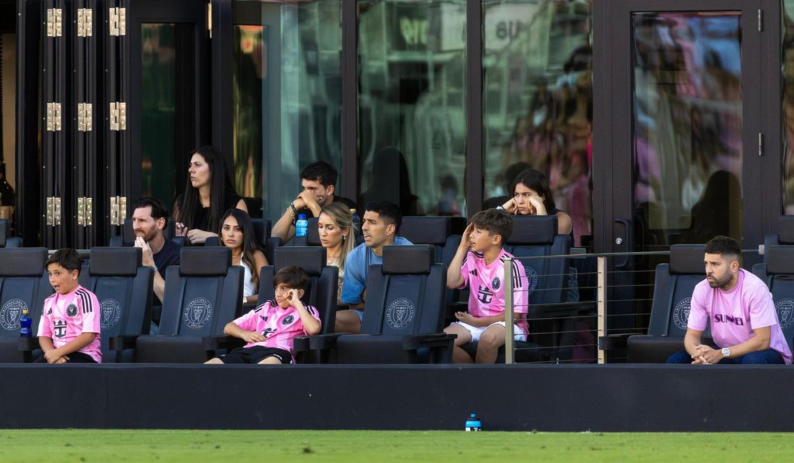 Inter Miami forward Lionel Messi, along with teammates Luis Suárez and Jordi Alba, watches from the stands with their families during the second half of their MLS match against FC Dallas at Chase Stadium on Sunday, April 27, 2025, in Fort Lauderdale, Fla.