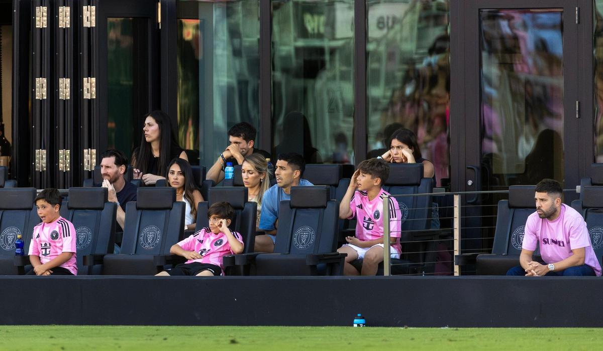 Inter Miami forward Lionel Messi, along with teammates Luis Suárez and Jordi Alba, watches from the stands with their families during the second half of their MLS match against FC Dallas at Chase Stadium on Sunday, April 27, 2025, in Fort Lauderdale, Fla.