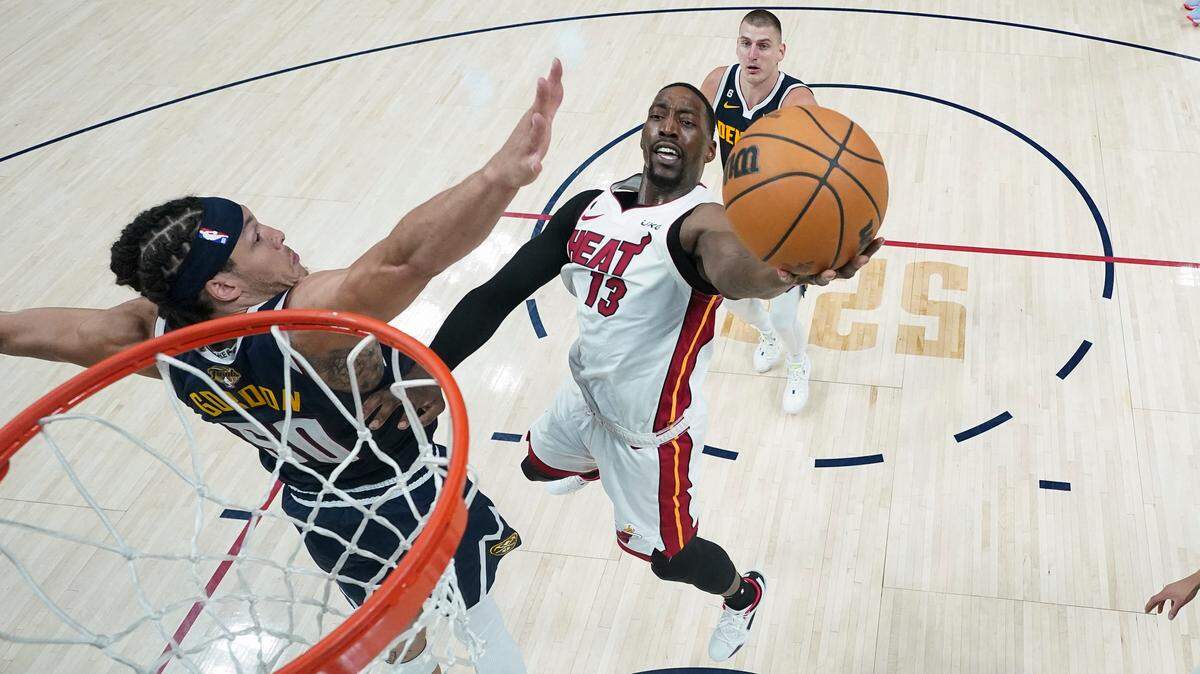 Miami Heat center Bam Adebayo (13) shoots the ball while defended by Denver Nuggets forward Aaron Gordon, left, during the second half of Game 2 of basketball’s NBA Finals, Sunday, June 4, 2023, in Denver. (AP Photo/Mark J. Terrill, Pool)