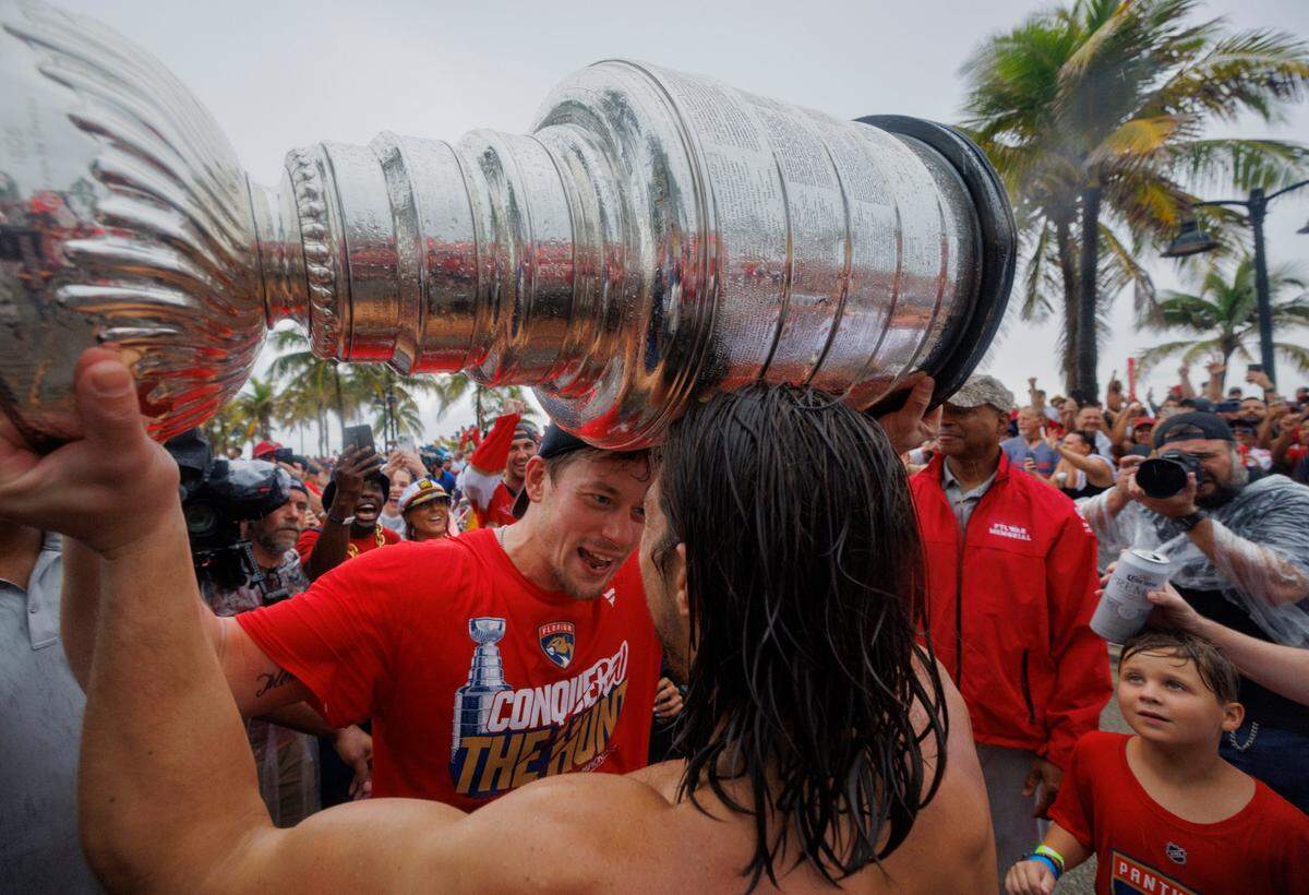 Florida Panthers right wing Vladimir Tarasenko (10) hands the Stanley cup to Florida Panthers left wing Ryan Lomberg (94) during the Florida Panthers Stanley Cup Victory parade on Sunday, June 30, 2024 down Fort Lauderdale Beach. 