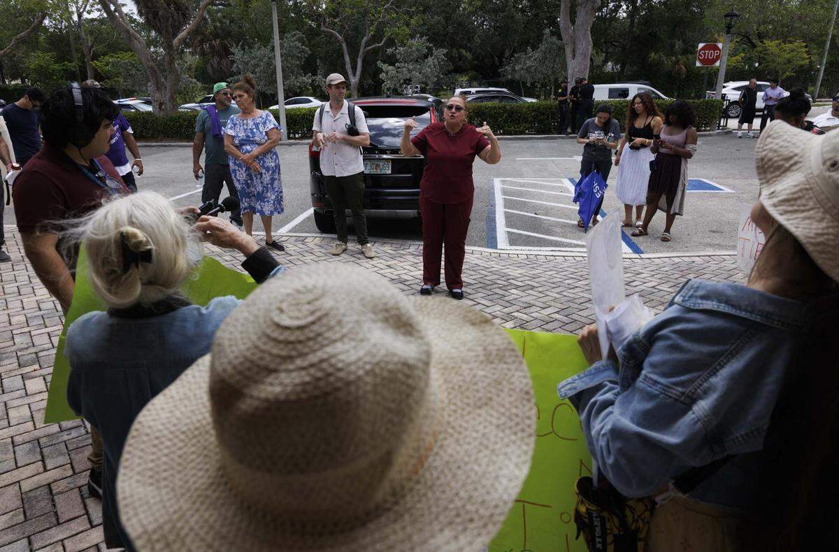 People gather during a protest outside of Miami District 4 Commissioner Ralph Rosado's office on Wednesday, May 27, 2026, at Coral Gate Park in Coral Gables, Fla. “I have a deep sense of community and this is an injustice. There's always gonna be a group of people who can't afford the rent [other places],” said Victoria Diaz, trailer park resident for 25 years. 