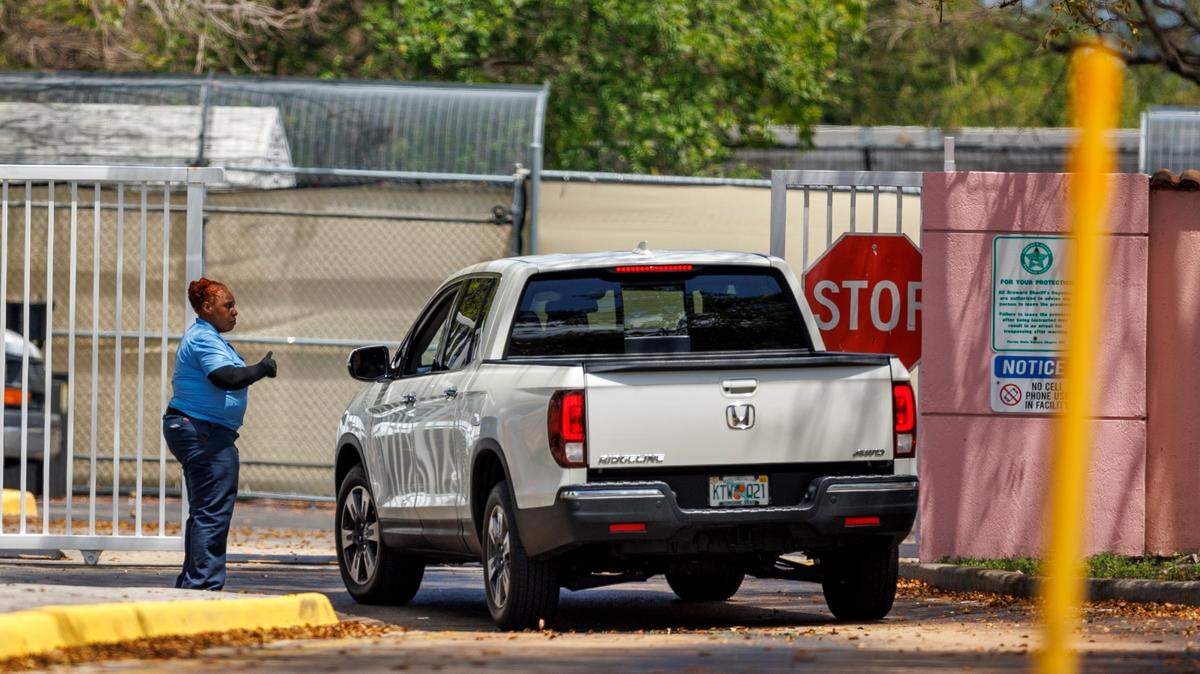 Security personnel stop a vehicle at the entrance of the Broward Transitional Center in Pompano Beach, Florida, on Tuesday, April 18, 2023