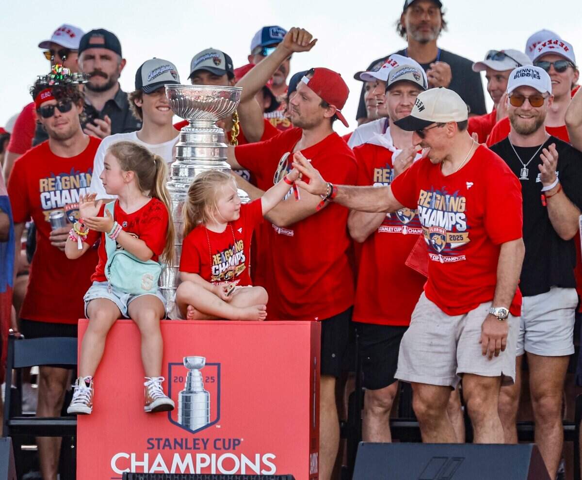 Florida Panthers center Brad Marchand celebrates with teammates and family on stage during the team’s Stanley Cup victory parade and rally along A1A in Fort Lauderdale, Florida, on Sunday, June 22, 2025.