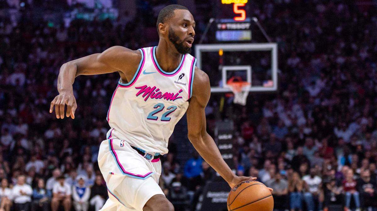 Miami Heat forward Andrew Wiggins (22) dribbles toward the paint during the first half of an NBA game against the Boston Celtics at Kaseya Center on February 10, 2025, in Miami.
