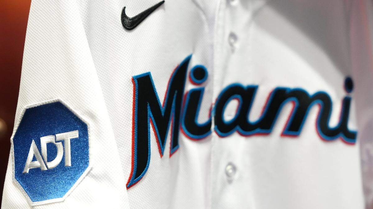 Miami Marlins player jerseys will feature patches with the corporate logo of Boca Raton-based home security company ADT, starting with the 2023 baseball season.