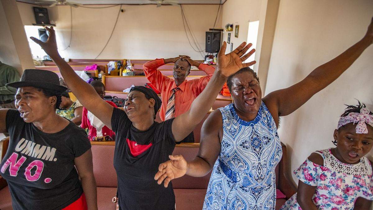 Delanie Celus, Dejanie Louisaint, Adeline Pierre and Nadine Gene, left to right, Haitian residents of the Bahamas, sing during service at First Beraca Baptist Church on Abaco Island after Dorian’s destruction.