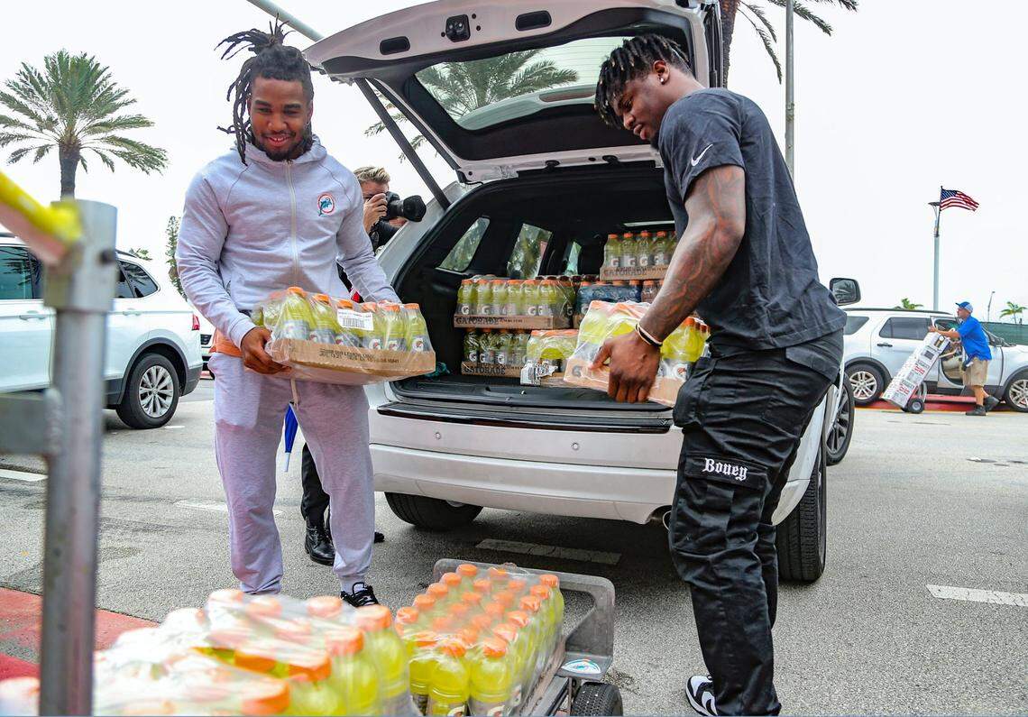 Miami Dolphins players Jaylen Waddle and Jerome Baker, left to right, deliver supplies on Friday, June 25, 2021 at Town of Surfside Community Center for survivors of the 12-story oceanfront condo, Champlain Towers South, that partially collapsed early Thursday morning.
