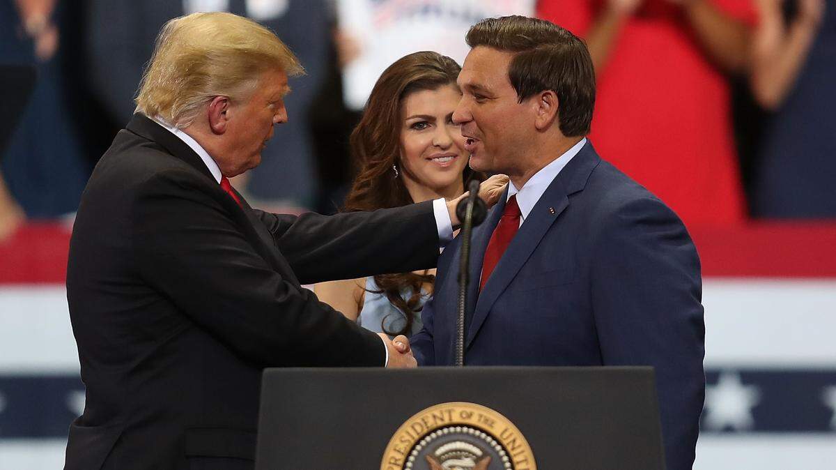President Trump greets then-gubernatorial candidate Ron DeSantis during a campaign rally in Estero, Florida, in October 2018.