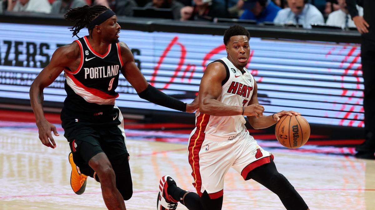 Miami Heat guard Kyle Lowry,right, drives down court as Portland Trail Blazers forward Jerami Grant, left, defends during the first half of an NBA basketball game in Portland, Ore., Wednesday, Oct. 26, 2022.