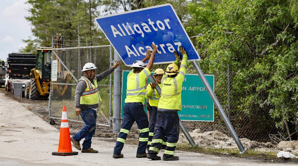Workers install a permanent Alligator Alcatraz sign. The facility is within the Florida Everglades, 36 miles west of the central business district of Miami, in Collier County, Florida. , Florida, on Thursday, July 3, 2025.