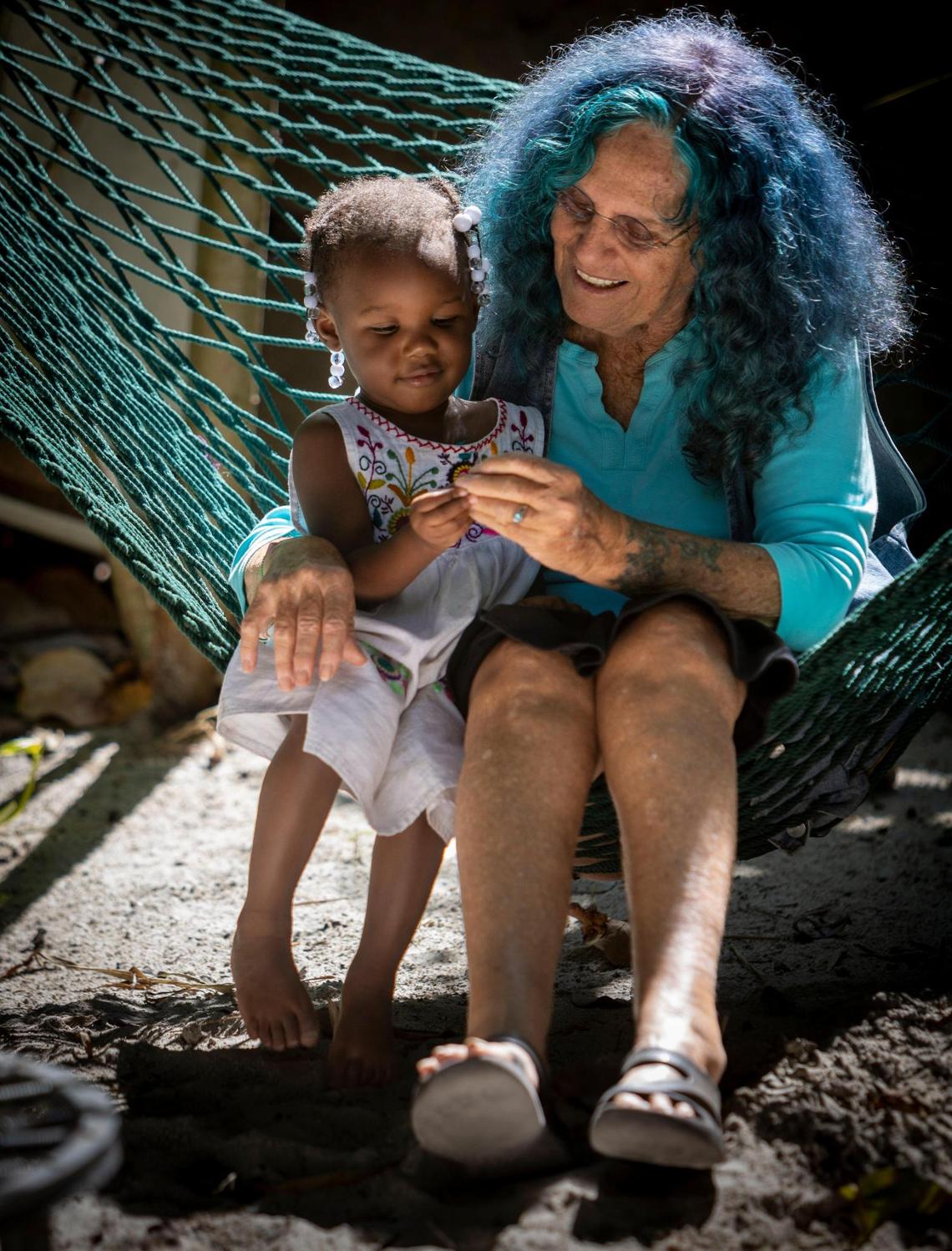 Shawnee Chasser plays with 2-year-old Zamara on a hammock on her property at NW 135th Street in unincorporated Miami-Dade on Friday, Sept. 8, 2023.