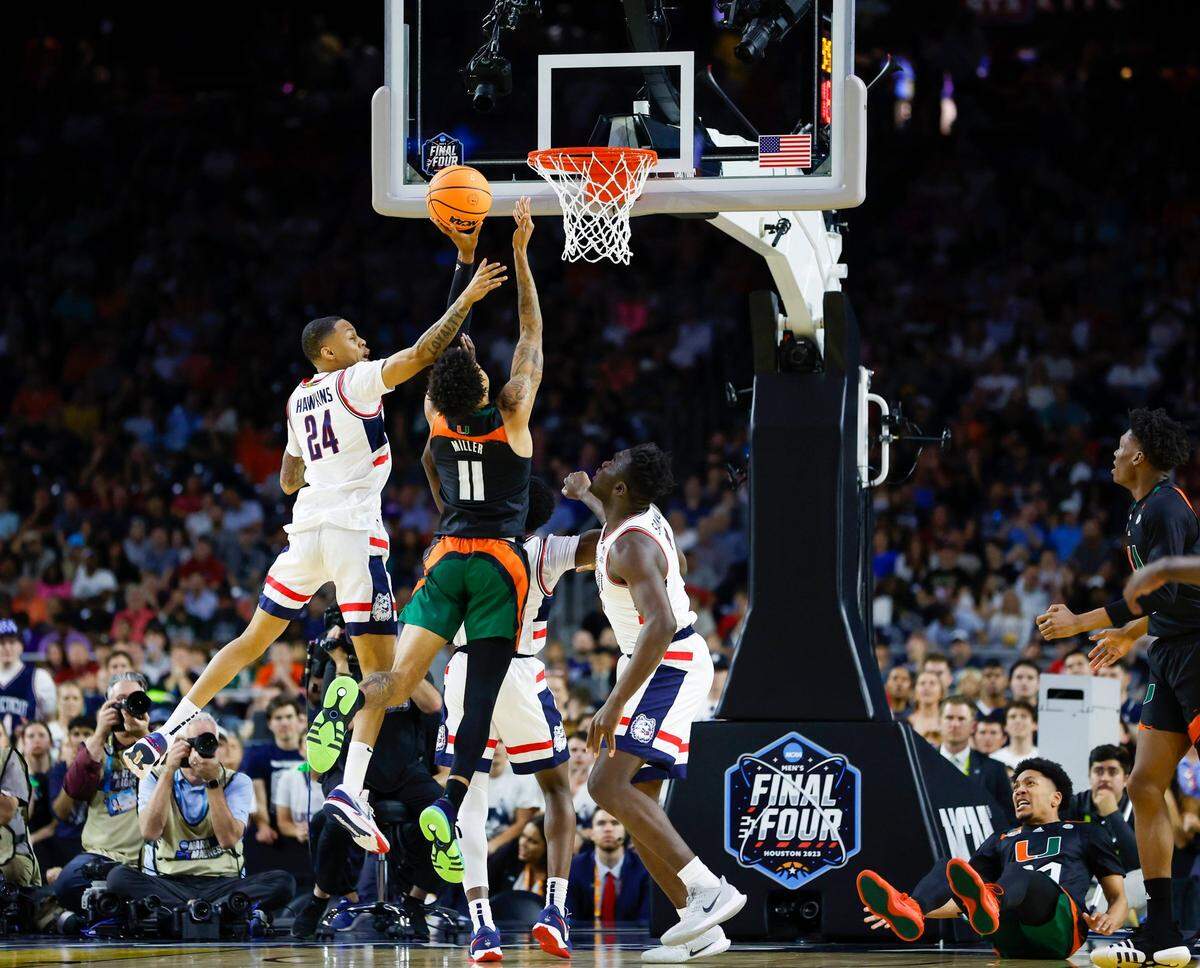 Connecticut Huskies guard Jordan Hawkins (24) defends Miami Hurricanes guard Jordan Miller (11) during the first half of the Men’s Basketball Championship National Semifinal at NRG Stadium in Houston, Texas on Saturday, April 1, 2003.