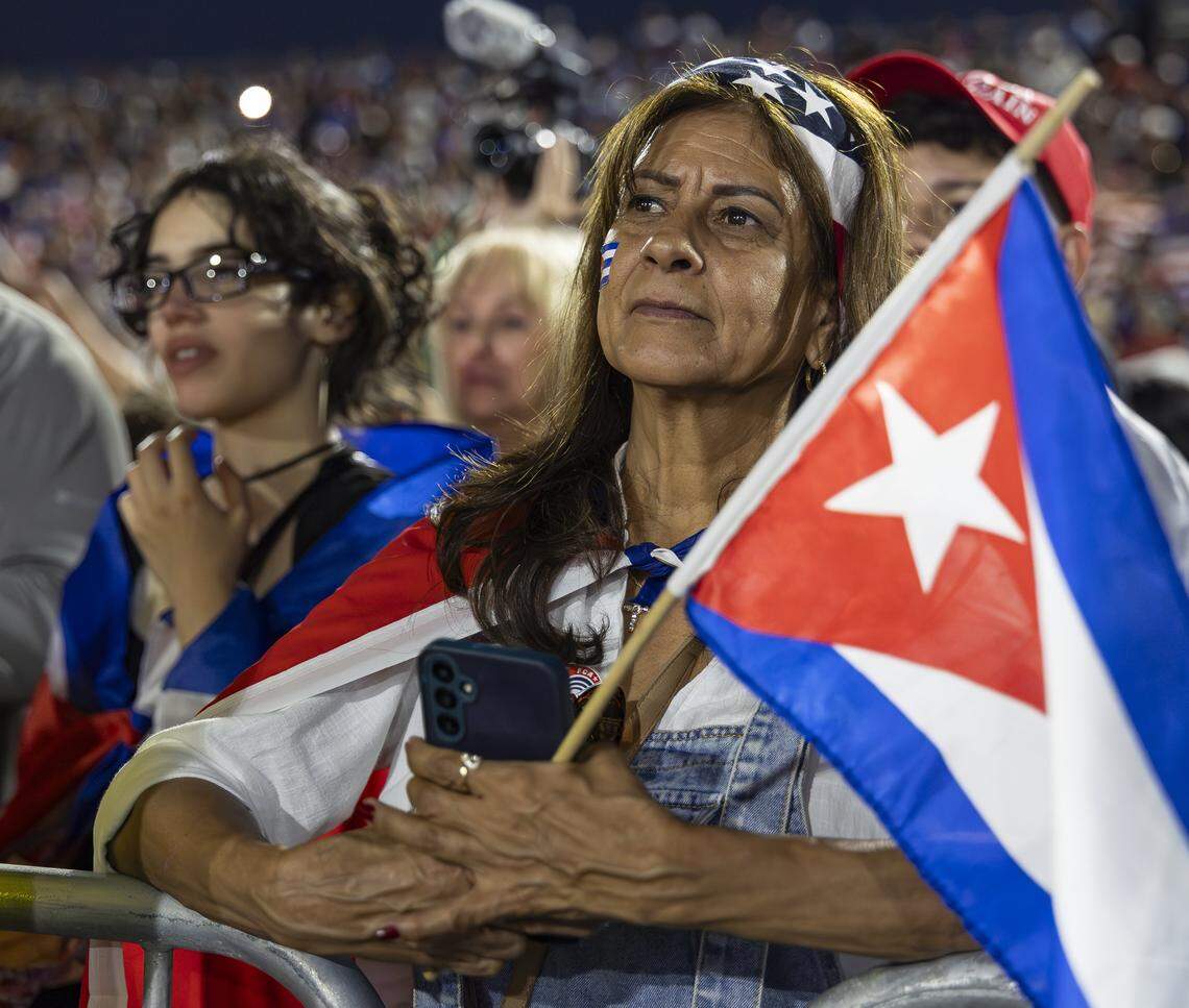 A woman listens to a speaker while attending the Free Cuba Rally at Milander Park on Tuesday, March 24, 2026, in Hialeah, Fla. The demonstration, which was organized in part by the City of Hialeah, aims to bring together voices of the Cuban exile community in support of Cuba's freedom.