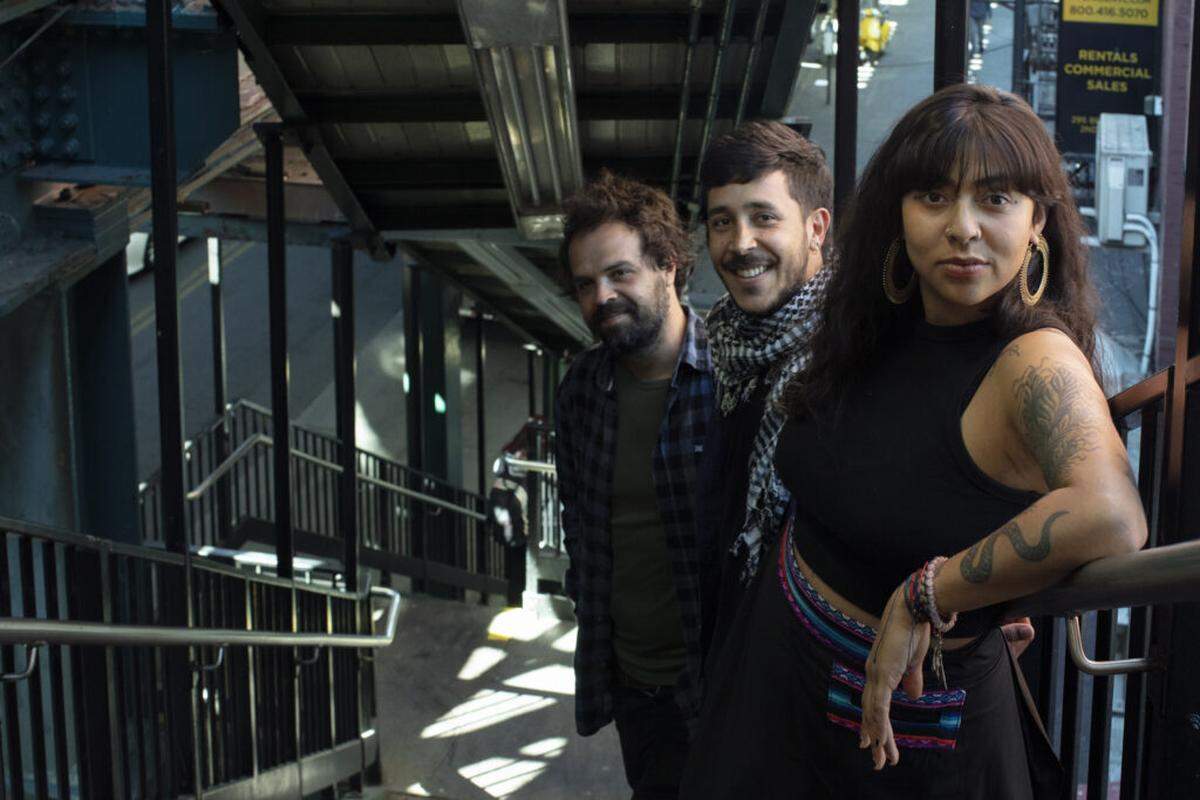 La Muchacha and her trio, El Propio Junte. From left, Camilo Bartelsman, drums; Miguel Velásquez Matijasevic, bass, and Isabel Ramirez Ocampo, vocals, guitar, are part of a double bill at the Miami Beach Bandshell on Saturday, April 5. 