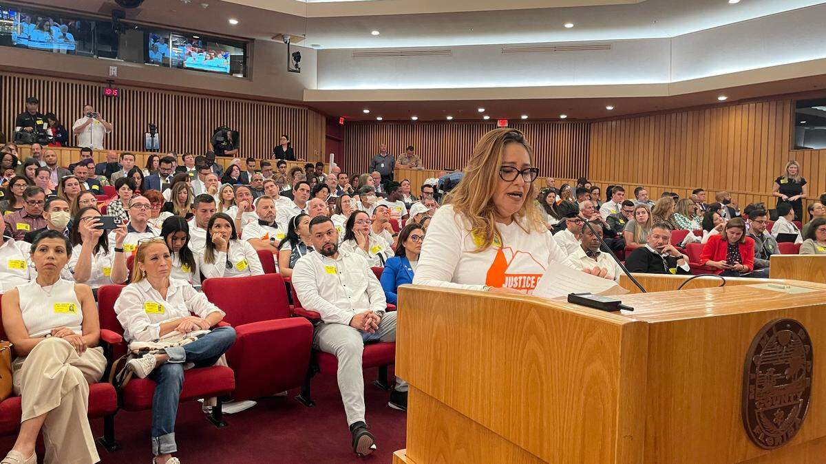 Gina Romero urges Miami-Dade County Commissioners to drop Doral as the future location for the county-run trash incinerator that caught fire last month. Her fellow Doral residents wore white for the meeting on Tuesday, March 7, 2023.