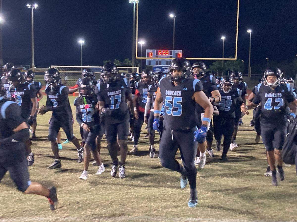 West Broward players run onto the field at Cypress Bay High just before their Region 4-6A semifinal playoff game against Monarch.