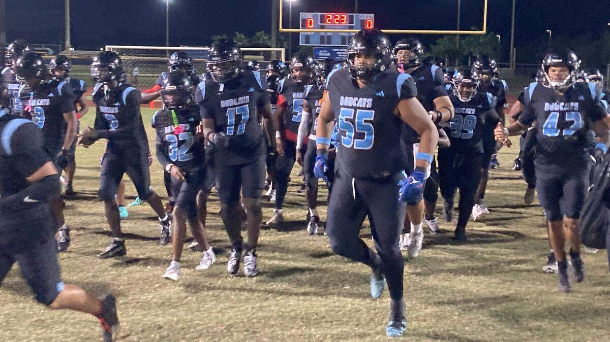 West Broward players run onto the field at Cypress Bay High just before their Region 4-6A semifinal playoff game against Monarch.