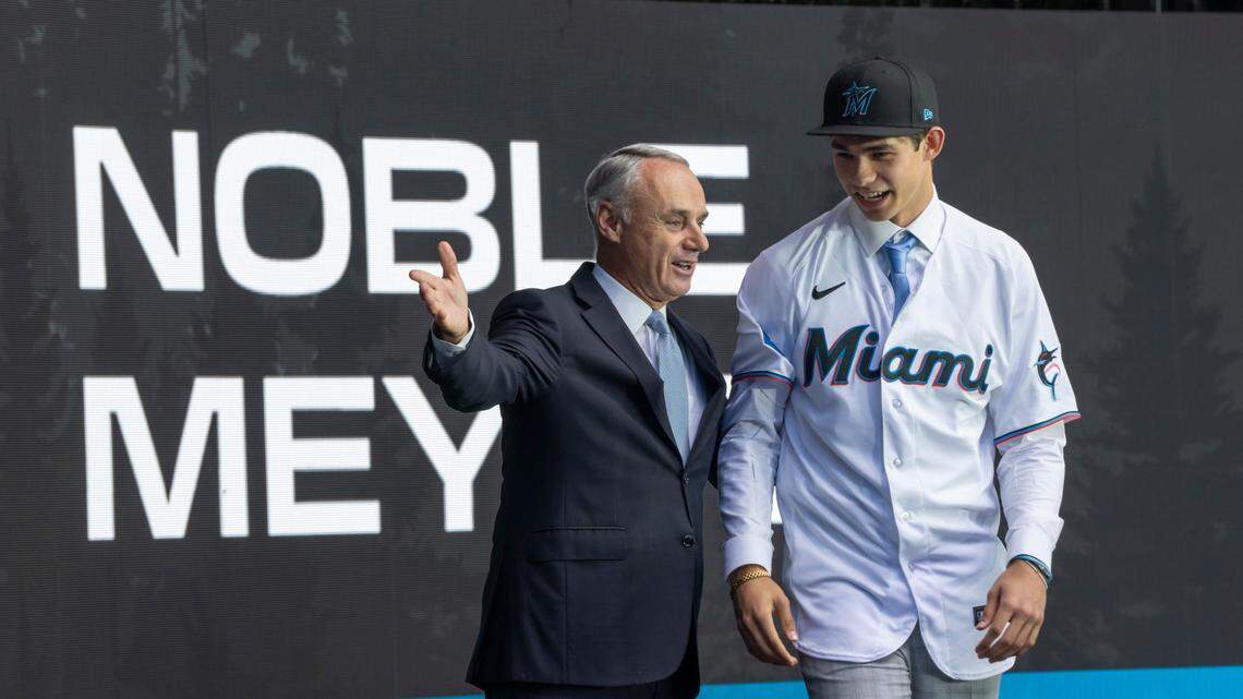 Miami Marlins draft pick Noble Meyer, right, is introduced by commissioner Rob Manfred during the first round of the MLB Draft at Lumen Field.