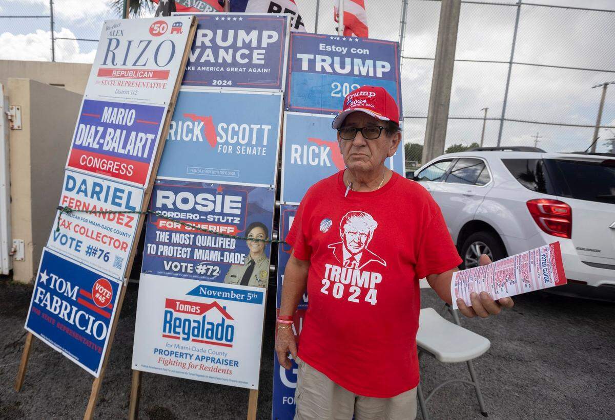 Orlando Bacallado campaigns during the first day of early in-person voting for the 2024 election at John F. Kennedy Library on Monday, October 21, 2024 in Hialeah, Florida.