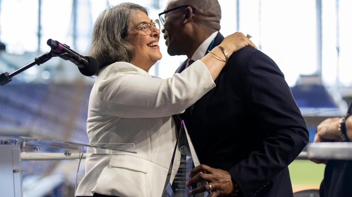 Miami-Dade County Mayor Daniella Levine Cava hugs Miami-Dade County Commissioner Jean Monestime, at the Building Blocks Housing Summit at LoanDepot Park in Miami on Thursday, June 30, 2022. The summit was focused on addressing the county’s home affordability crisis.