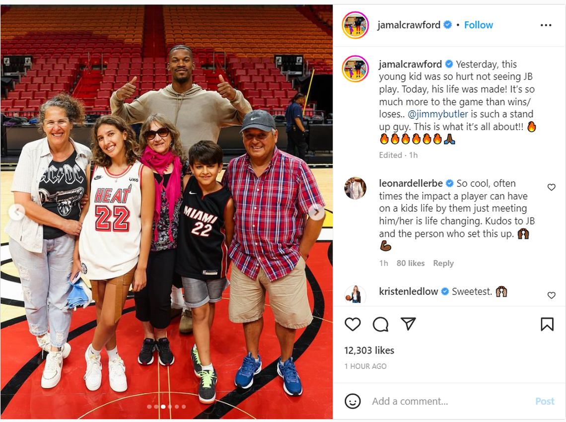 Heat star Jimmy Butler takes photos with 12-year-old Felipe, a fan from Argentina that traveled 4.405 miles to see him play. Butler did not play Tuesday, so he made it up the young fan and his family on Wednesday, Jan. 25, 2023 at FTX Arena.