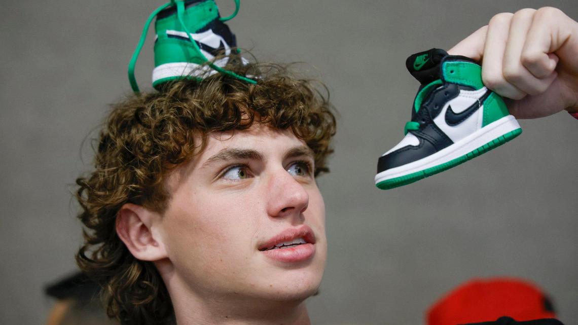 Jayden Leboeuf, 17, enjoys a newly purchased pair of baby Jordan sneakers during Sneaker Con at the Broward County Convention Center in Fort Lauderdale, Florida, on Saturday, Jan. 11, 2025.