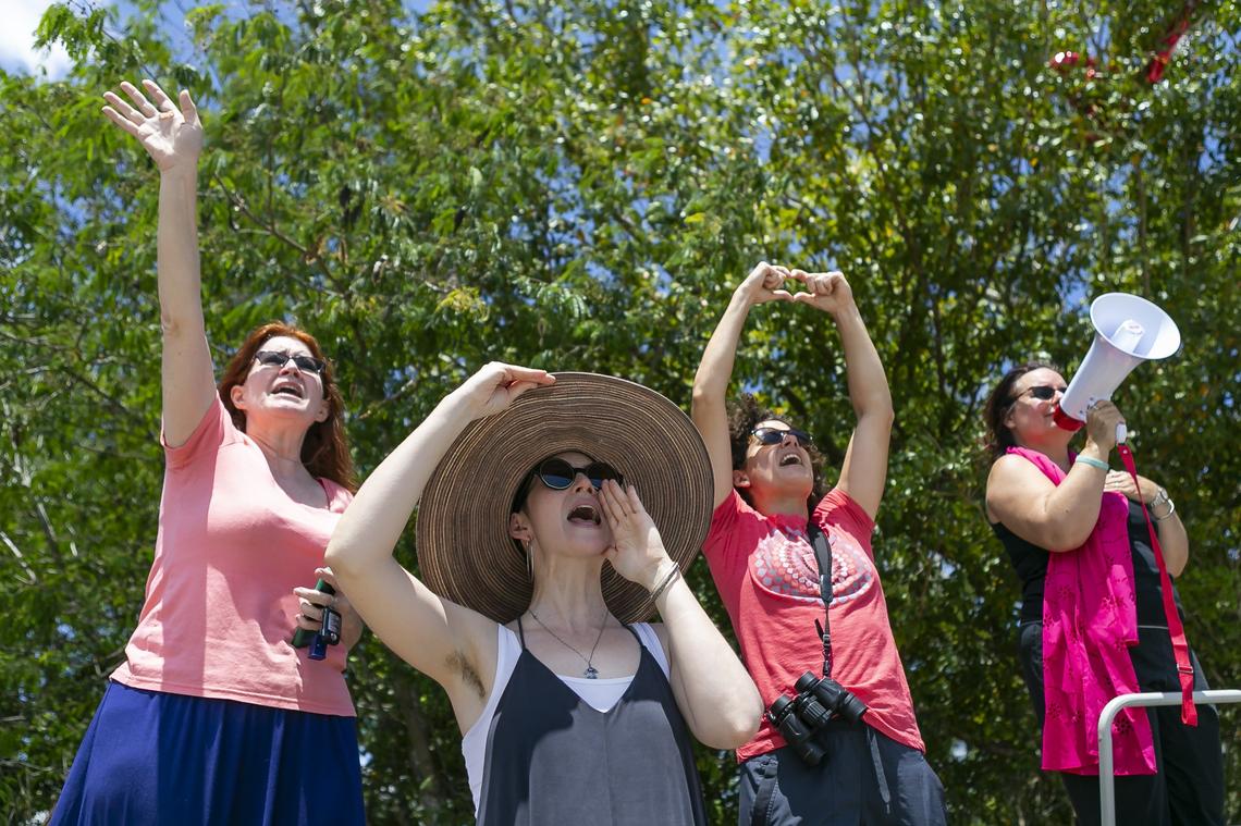 Madelyn Moyer, 35, bottom-center, yells alongside a group of activists protesting the Homestead Temporary Shelter for Unaccompanied Children during Good Friday in Homestead, Florida on April 19, 2019.