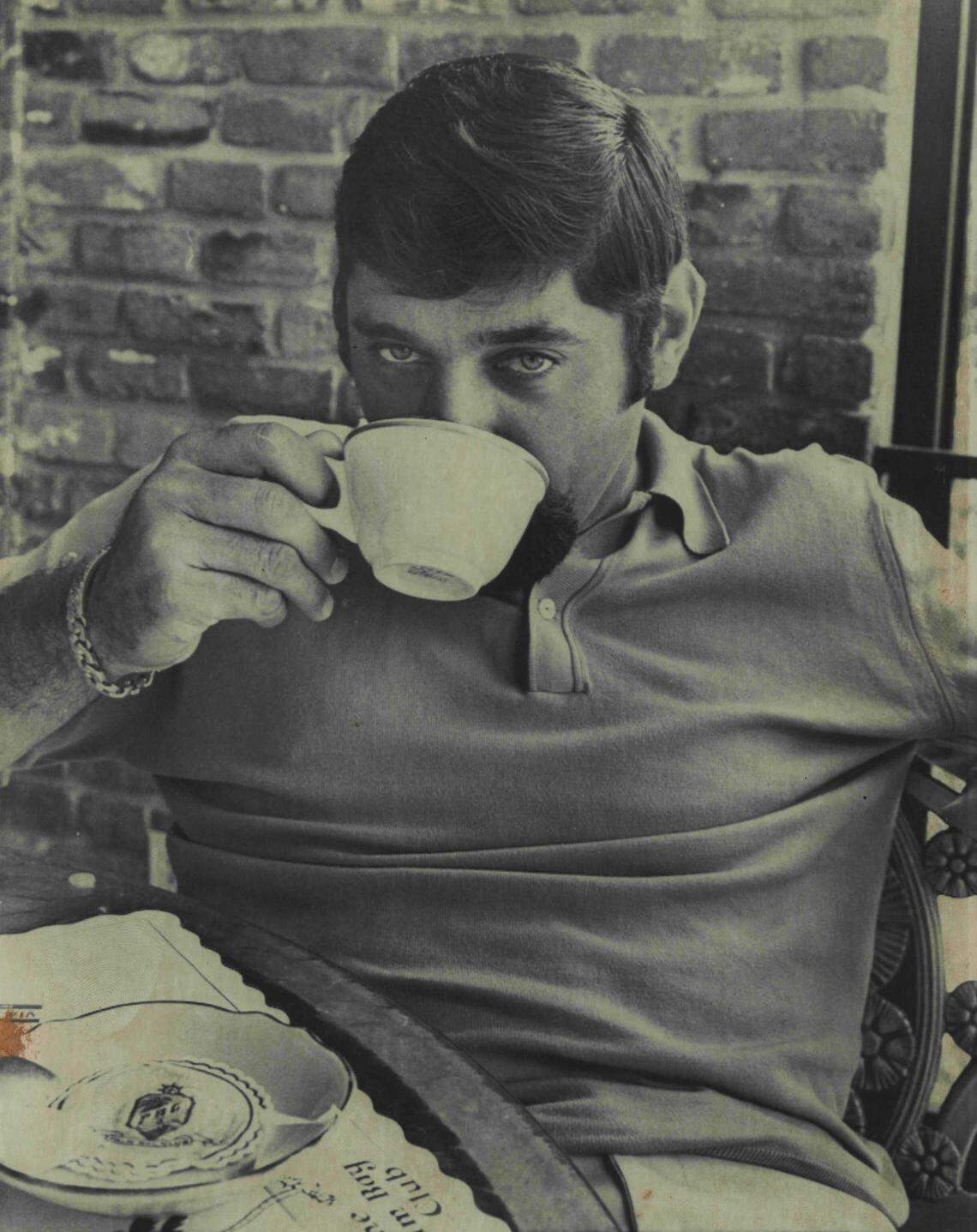 Former New York Jets quarterback Joe Namath relaxes with coffee after lunch at Miami's Palm Bay Club.