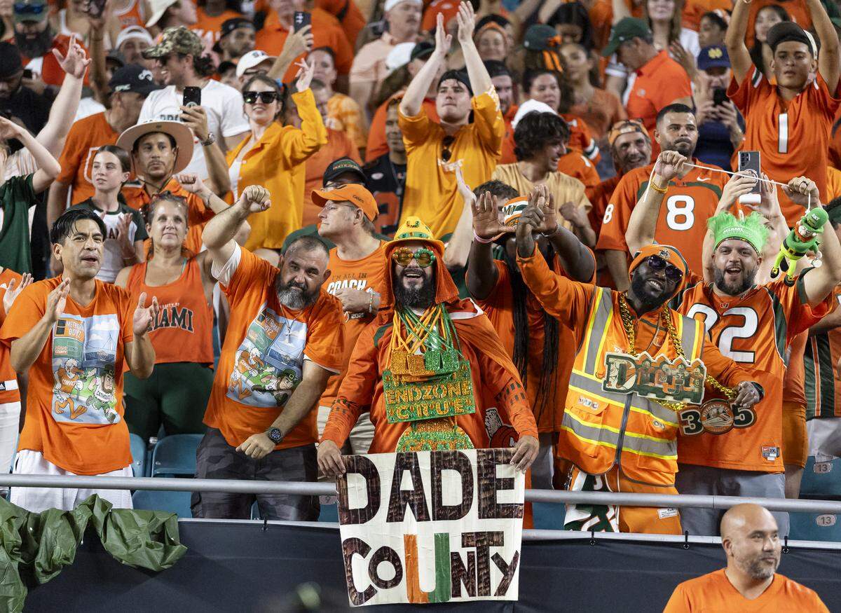 Miami Hurricanes fans cheer for their team after they defeated the Notre Dame Fighting Irish in their NCAA football game at Hard Rock Stadium on Sunday, Aug. 31, 2025, in Miami Gardens, Fla.