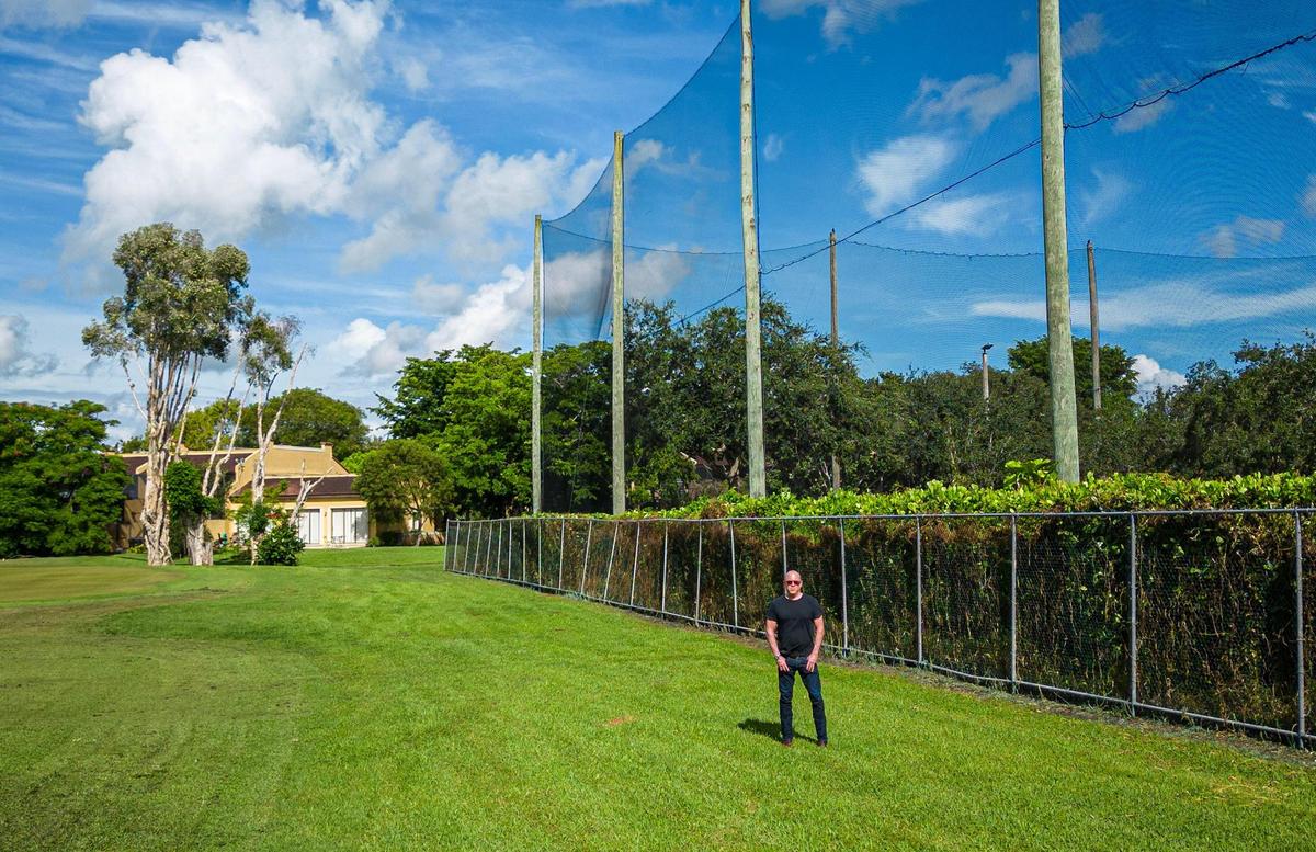 Jim Ferguson, president of Costa del Sol Home Association stands on Aug. 16, 2023 in the Costa Del Sol Golf Club turf next to the property line that would be altered, if developer Edward Abbo of the Apollo Companies builds the Oasis Doral. It’s a 17-acre residential and commercial project planned at the intersection of Doral Boulevard and Northwest 97th Avenue backing up to a pair of modest two-story townhomes Villas of Amberwood surrounding a golf course called Costa del Sol.