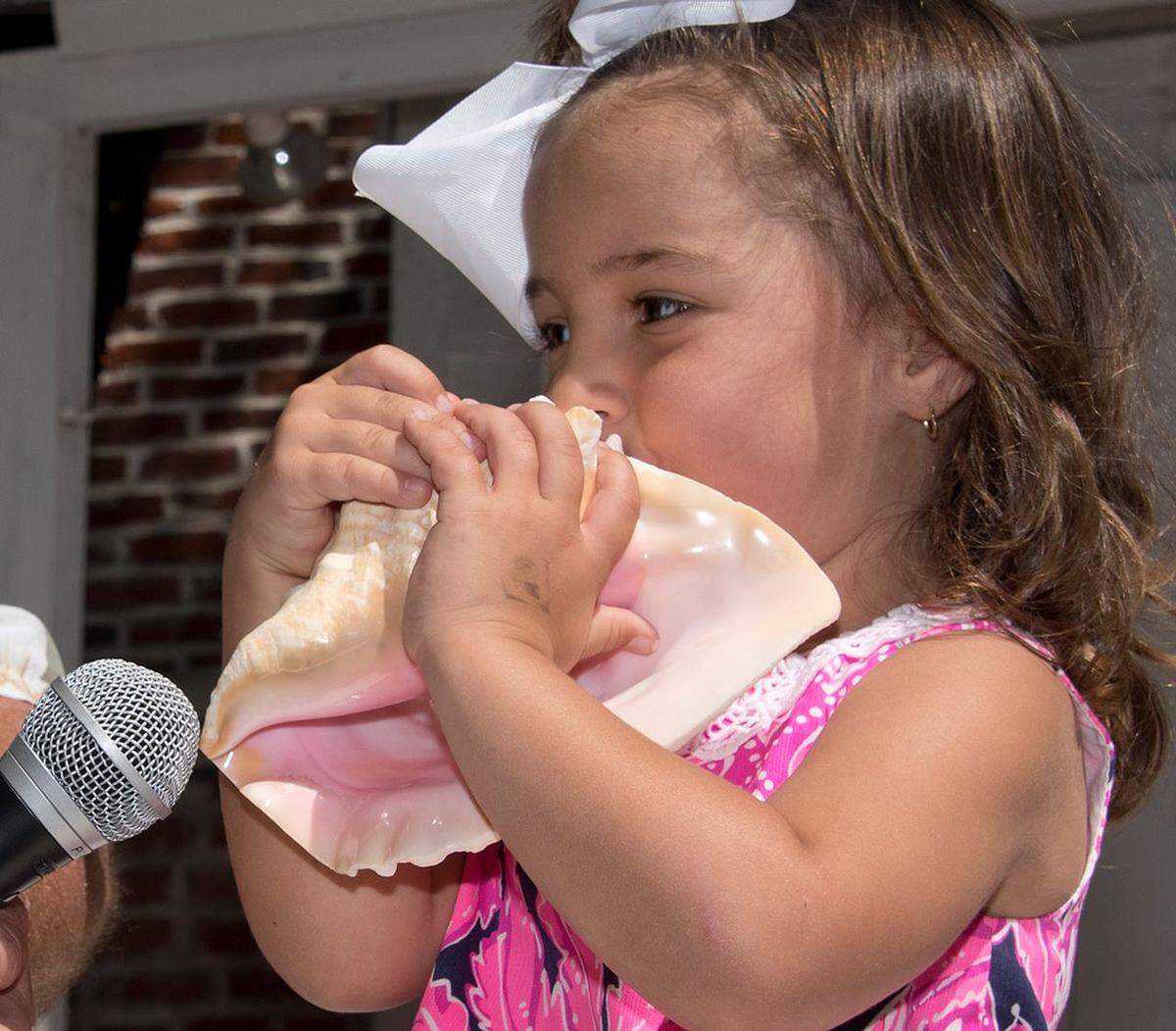 Cecelia Sheffer toots her conch shell during the Conch Shell Blowing Contest Saturday, March 4, 2017, in Key West, Fla. Three-year-old Sheffer of Key West was the youngest of dozens of entrants who were evaluated for the quality, duration, loudness and novelty of the sounds they produced. The fluted, pink-lined conch shell, a symbol of the Florida Keys, has been used as a signaling device in the islands for centuries. FOR EDITORIAL USE ONLY (Rob O’Neal/Florida Keys News Bureau/HO)