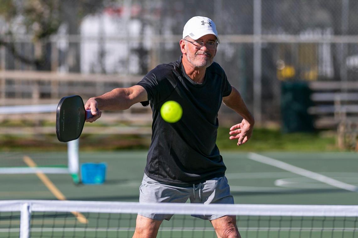 Charlie Bibb, 66, plays a game of pickleball at Suniland Park in Pinecrest, Florida on Friday, January 14, 2022.