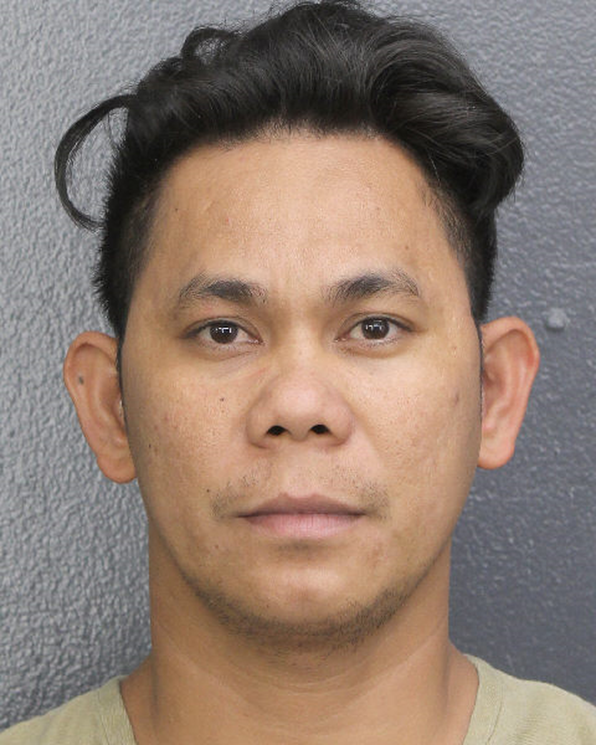 Cris John Pentinio Castor’s booking photo on Nov. 30, 2023, at Broward County detention center.